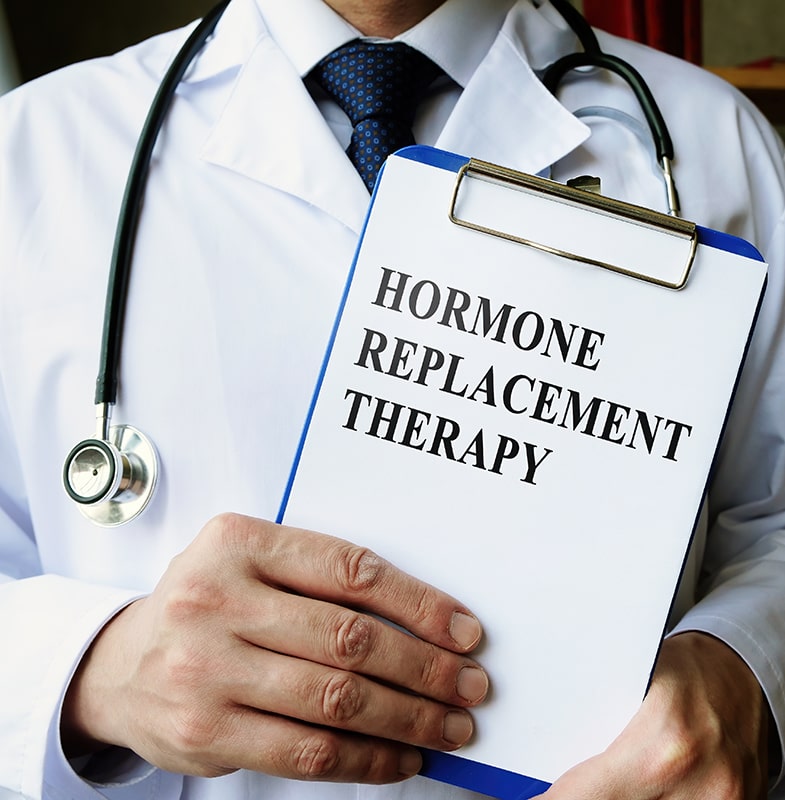 image of a doctor holding up a tablet that says Hormone Replacement Therapy